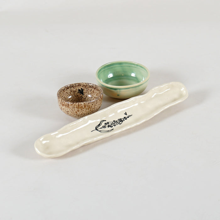 Handmade ceramic set featuring a small brown bowl, small green bowl, and white olive tray
